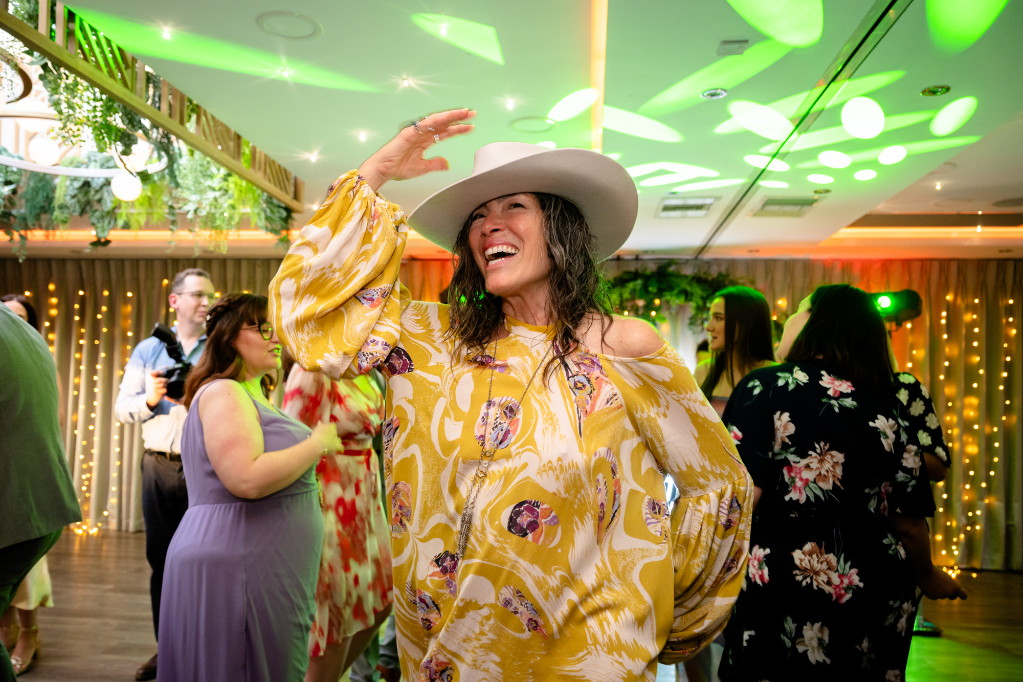 Woman dancing with a cowboy hat at Moddershall Oaks.