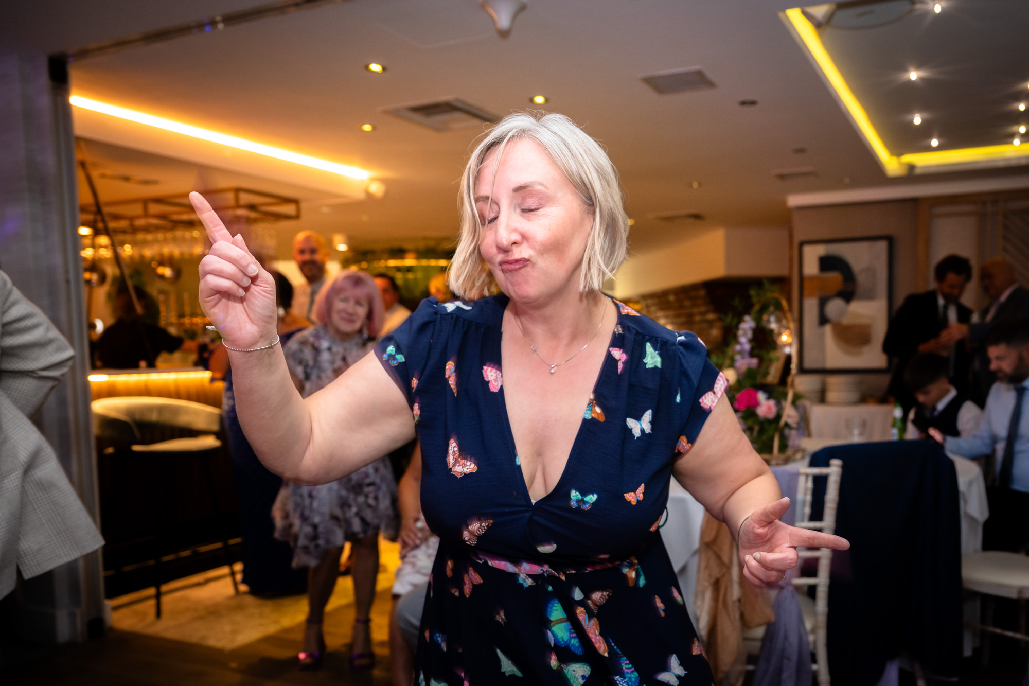 A blonde woman dancing at Moddershall Oaks.