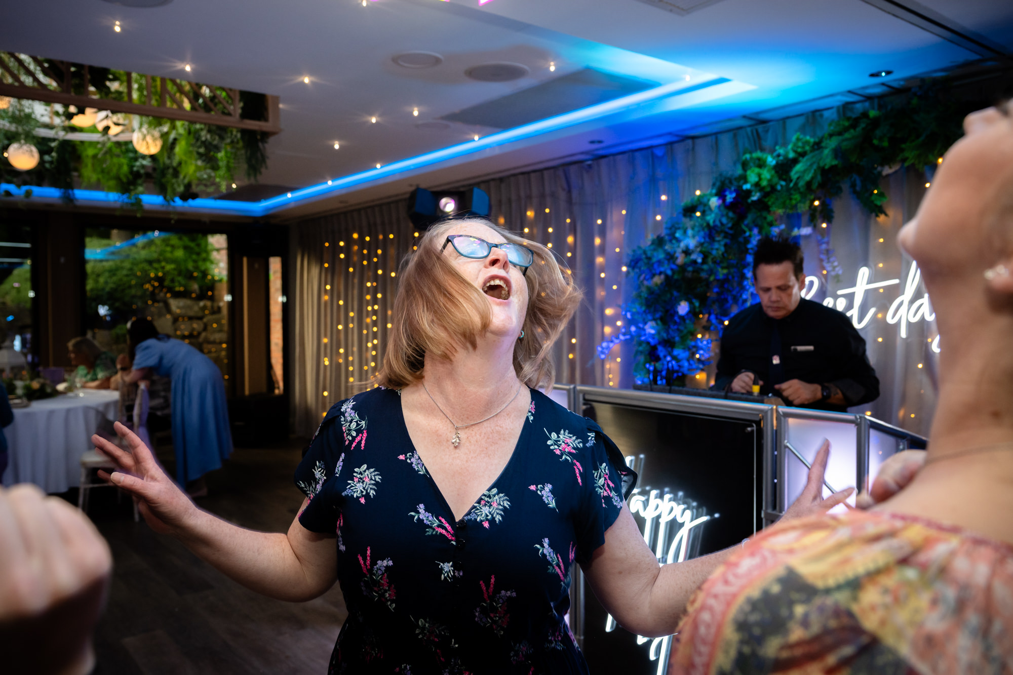 A woman shaking her head on the dancefloor at Moddershall Oaks.