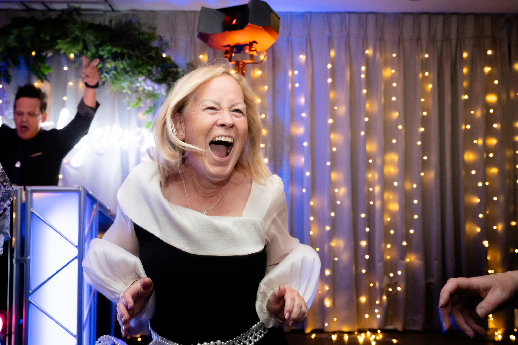 a woman smiling and dancing at Moddershall Oaks.