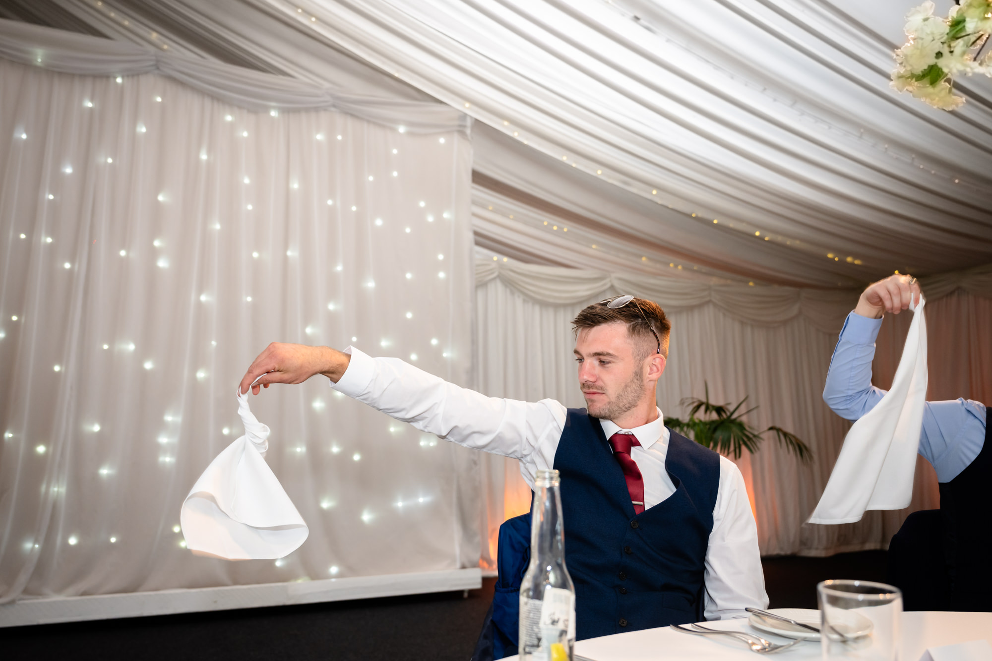The wedding breakfast entertainment at Heaton House Farm features a singer engaging with the guests.