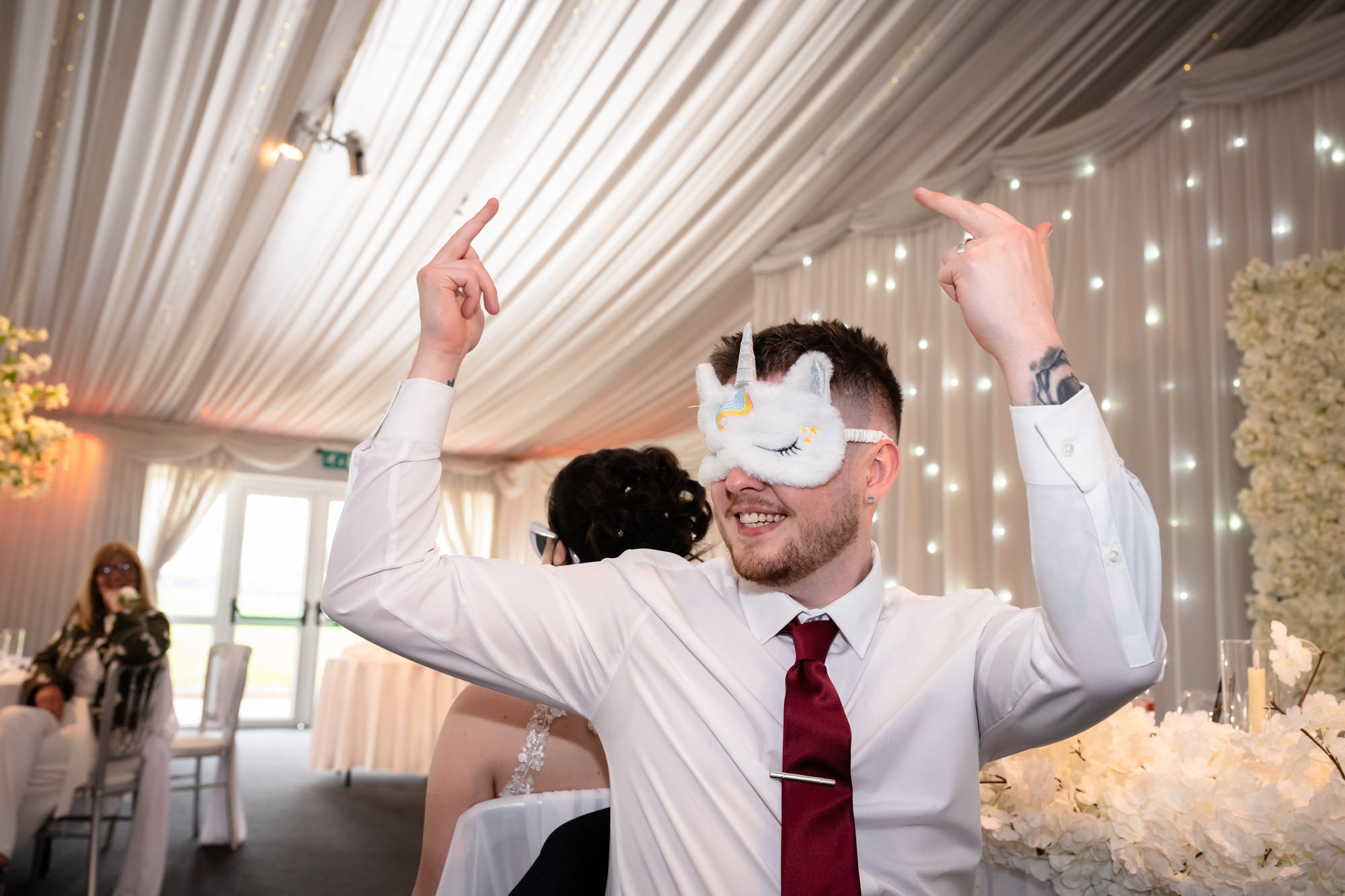 The groom wearing a mask play Mr and Mrs game at Heaton House Farm.