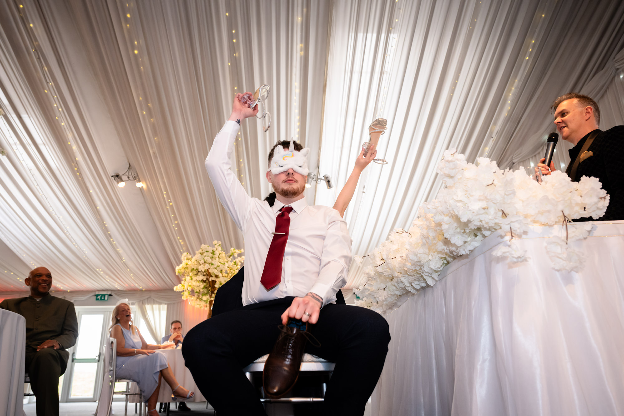 A fun moment from the Mr and Mrs game, as the groom answers a question during the wedding reception at Heaton House Farm.