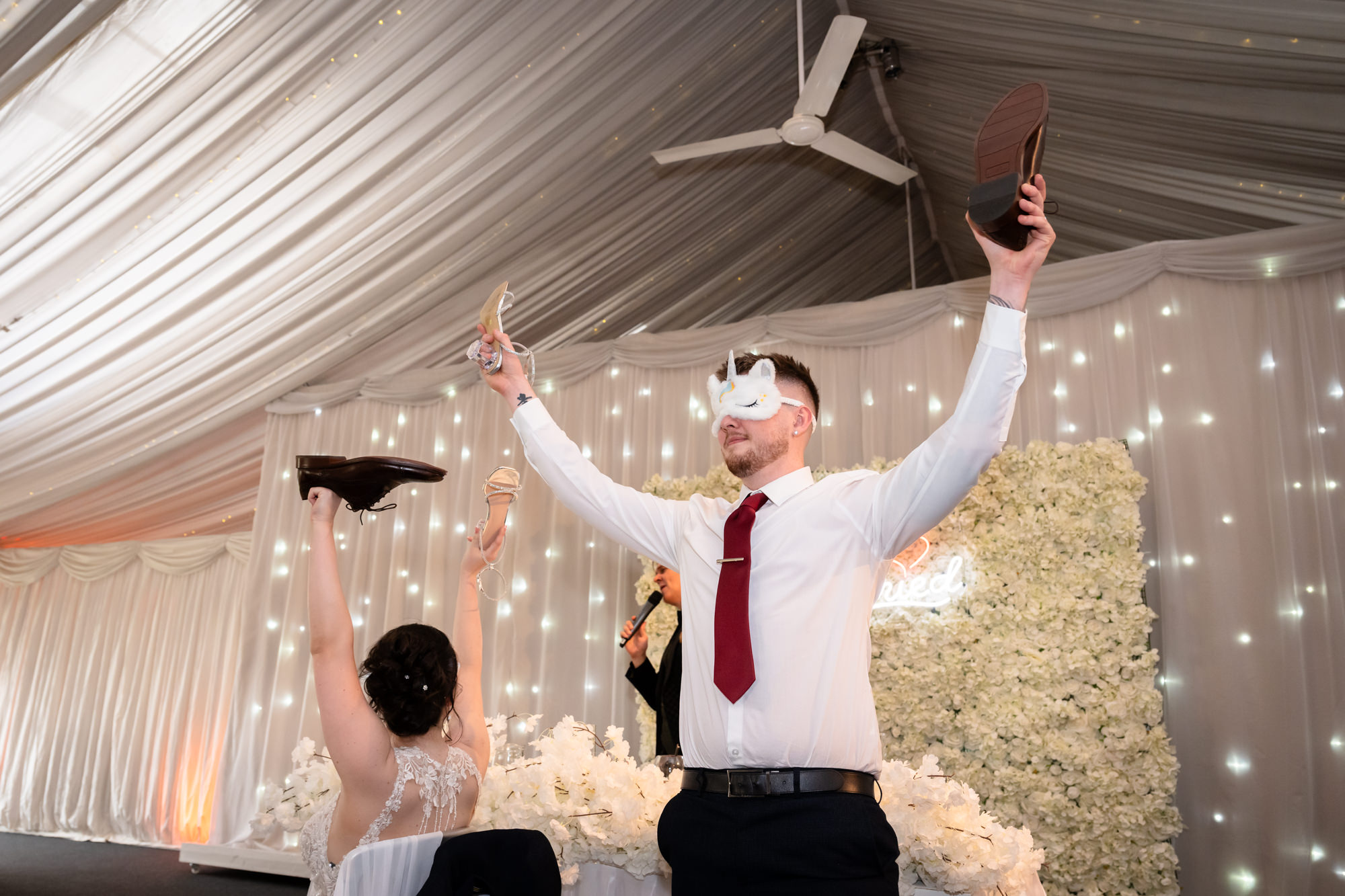 The groom enthusiastically raises his hands during the Mr and Mrs game at Heaton House Farm.