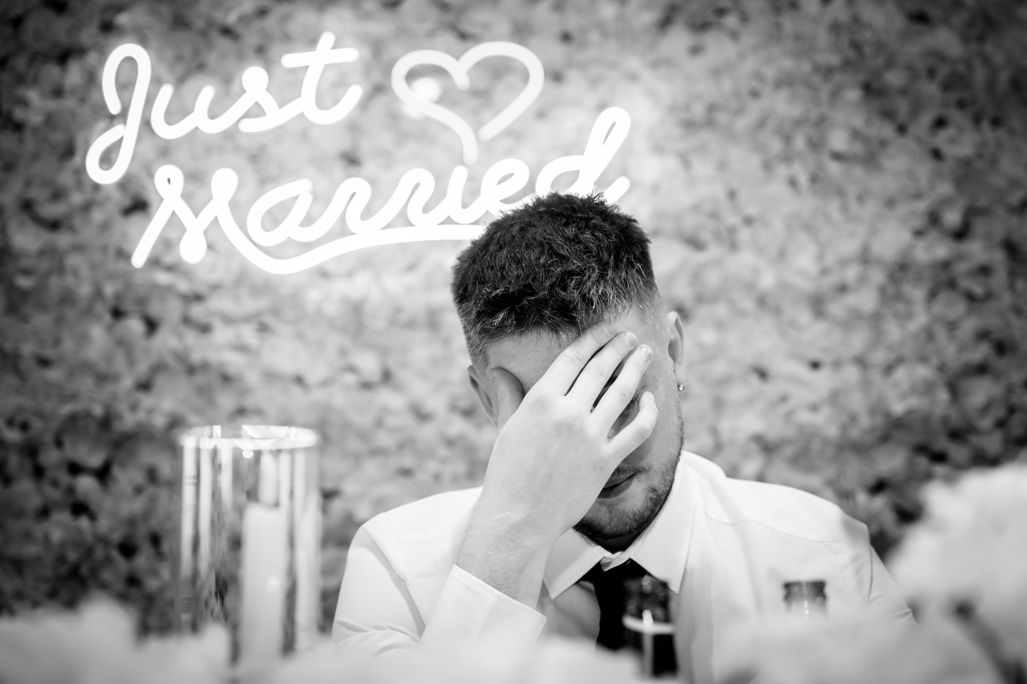 The groom is seen wiping a tear from his eye while giving a speech at Heaton House Farm.