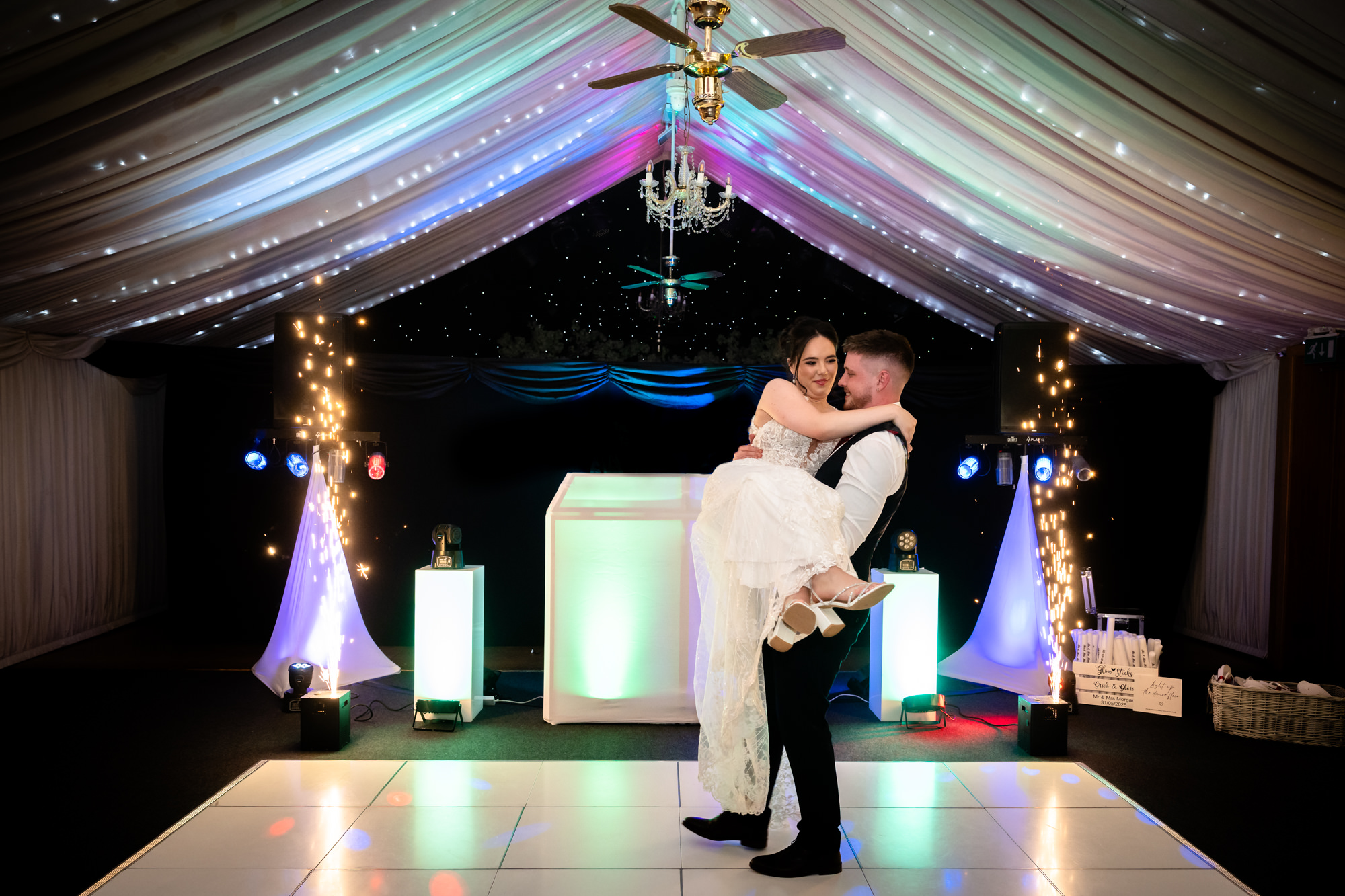 A beautiful shot of the groom lifting his new wife up during their first dance at Heaton House Farm.