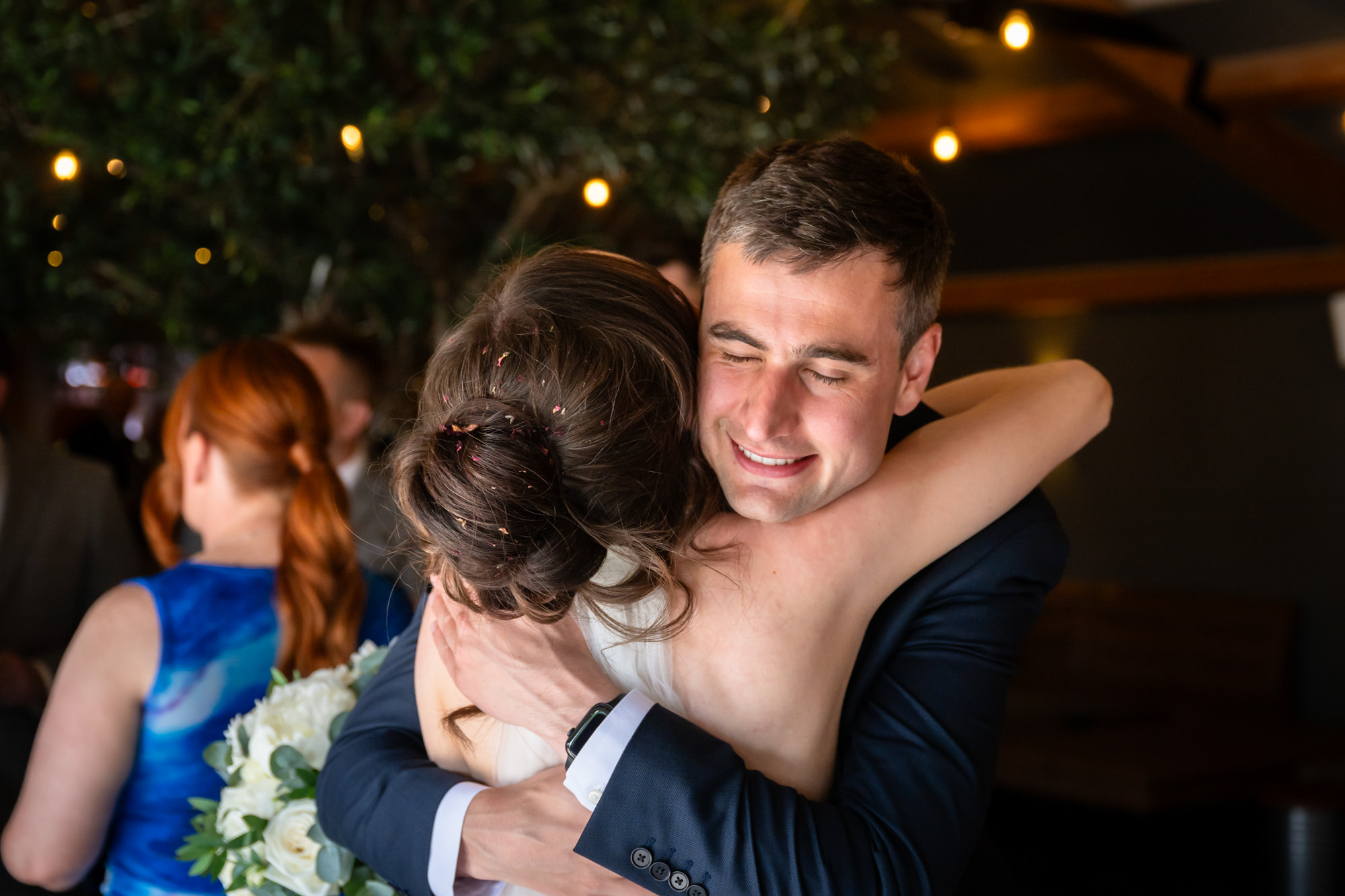 A guest hug the bride at Hanbury Barns.