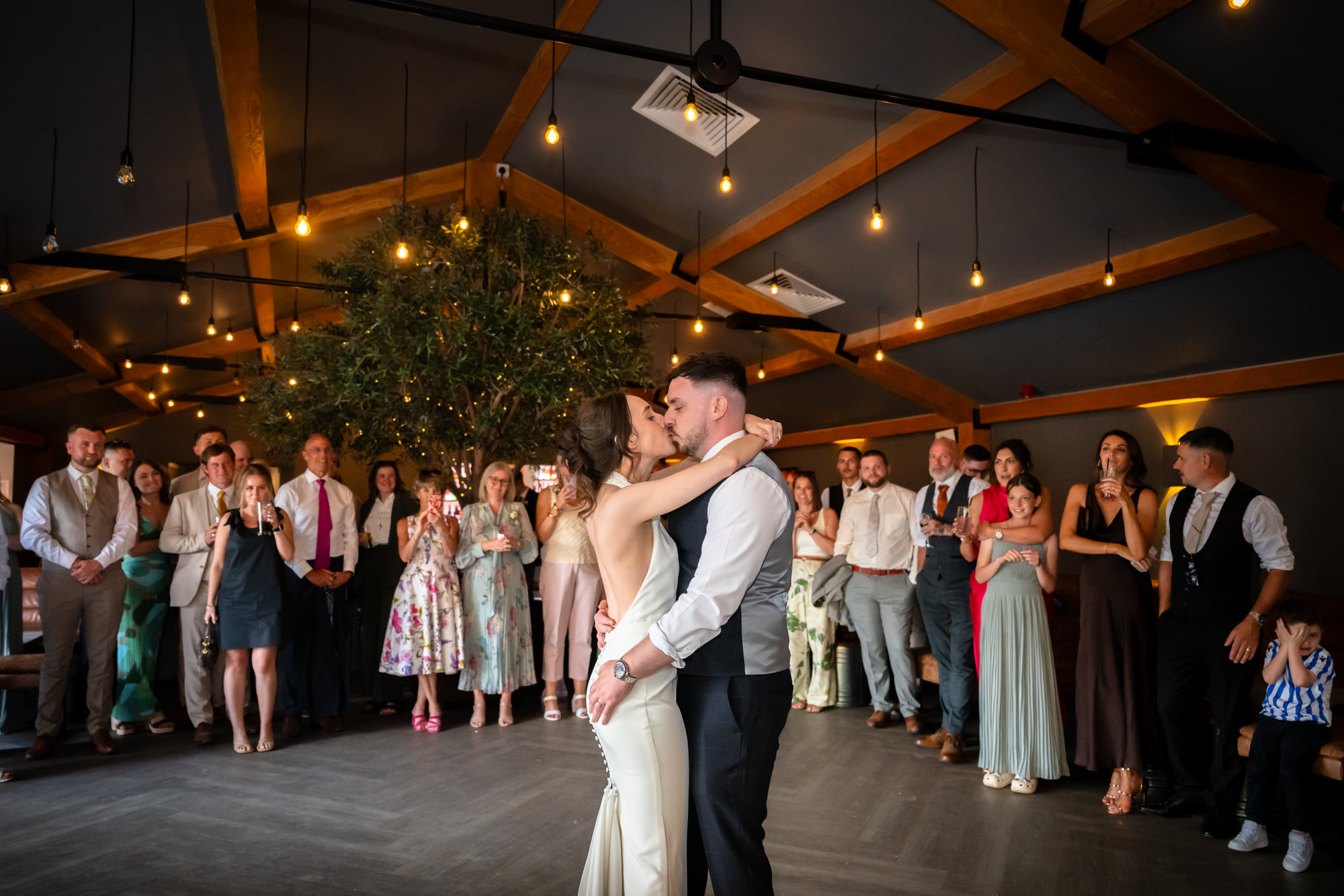 The bride and groom share a dance at the center of the dance floor during their first dance at Hanbury Barns.
