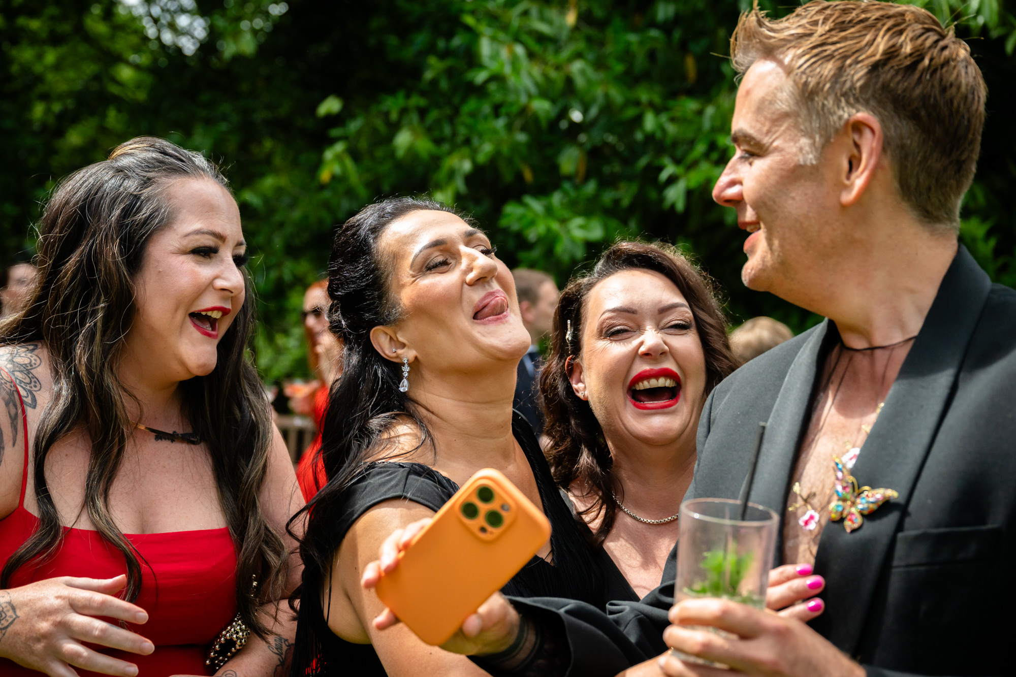 A group of people are laughing together in an outdoor area at Springbank Manor.