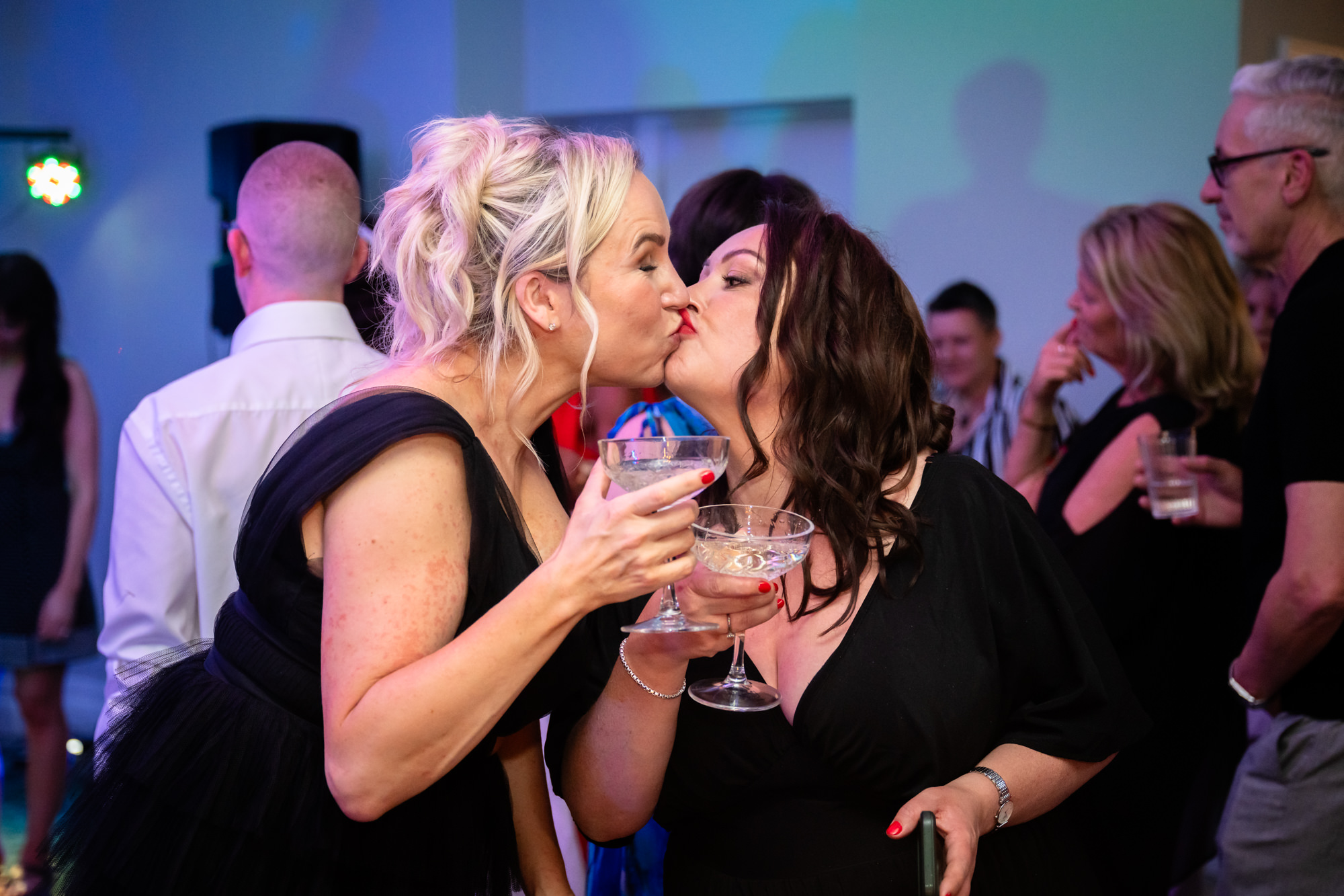 Two women share a kiss at the wedding at Springbank Manor.