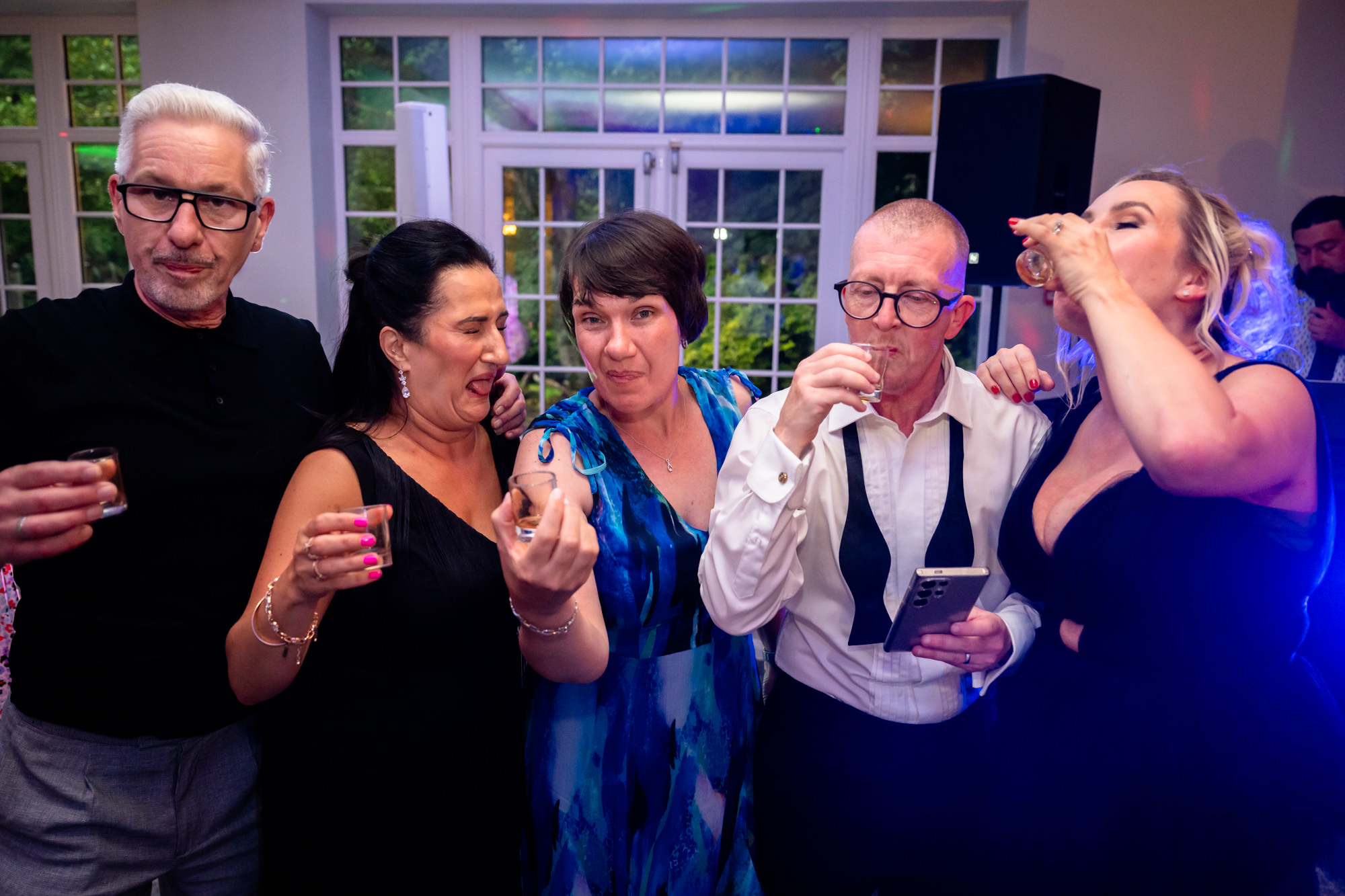 A group of people drinking shots