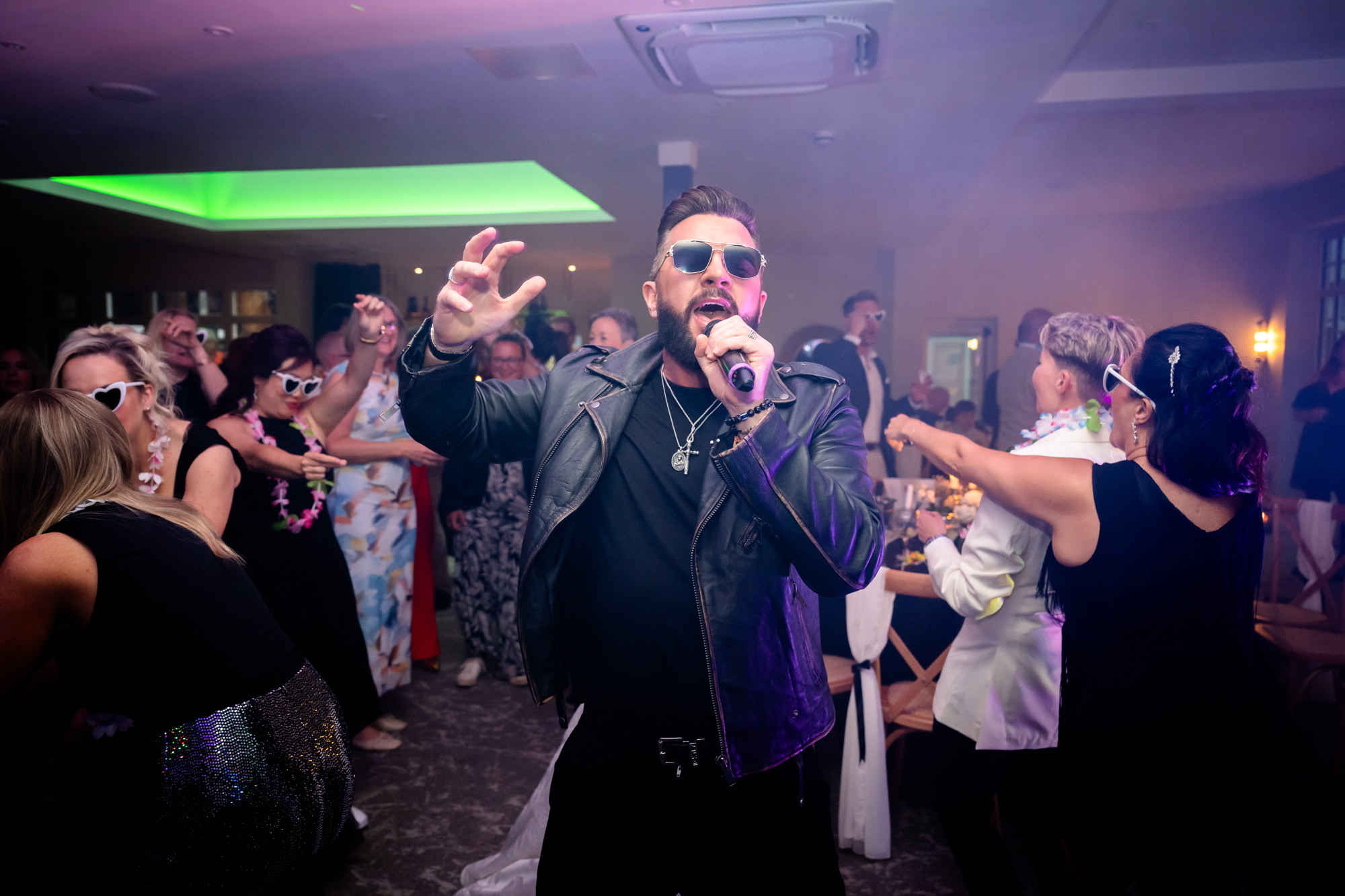 A George Michael impersonator performs for the crowd at the wedding party at Springbank Manor.