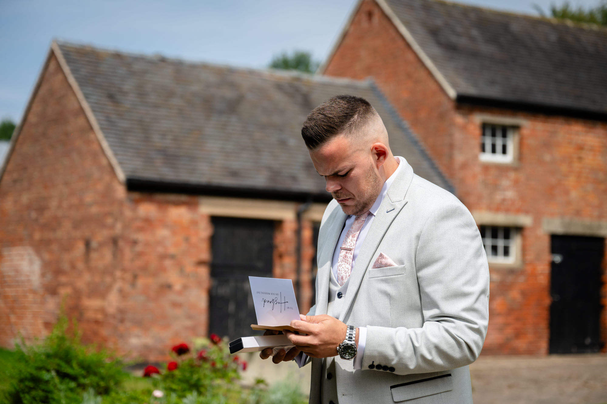 The groom reading a letter from his wife-to-be