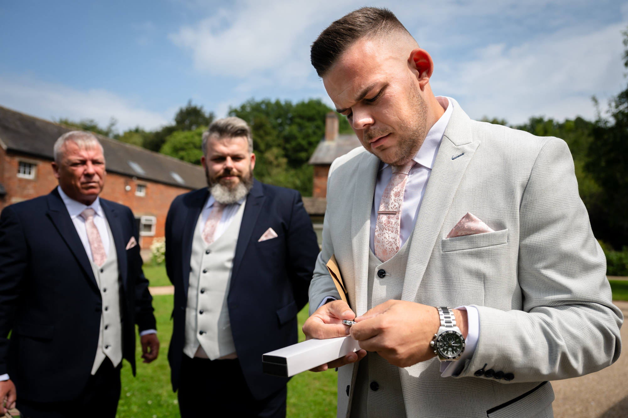 the groom opening a gift from his wife