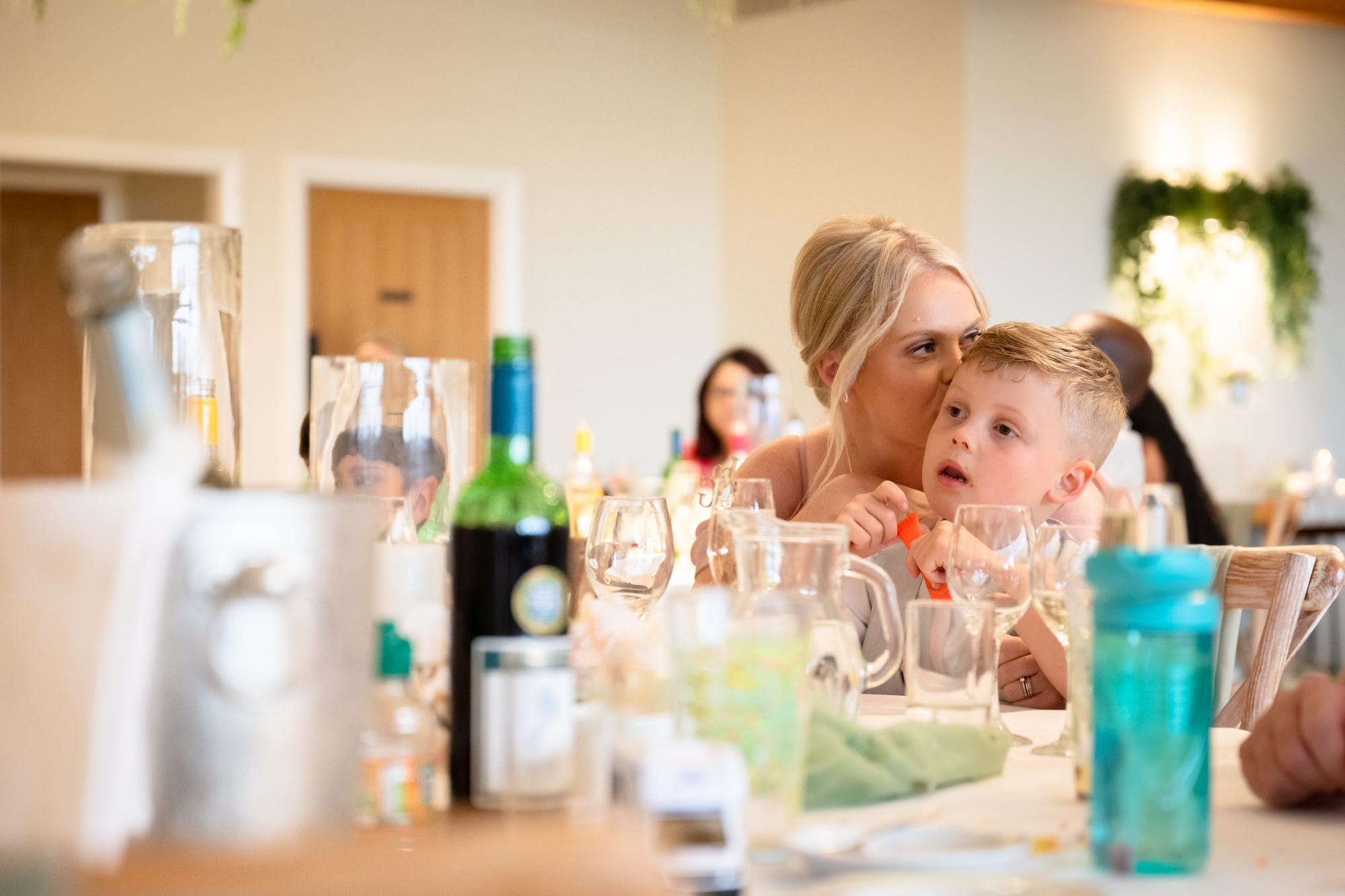 A woman is kissing her son during the speeches
