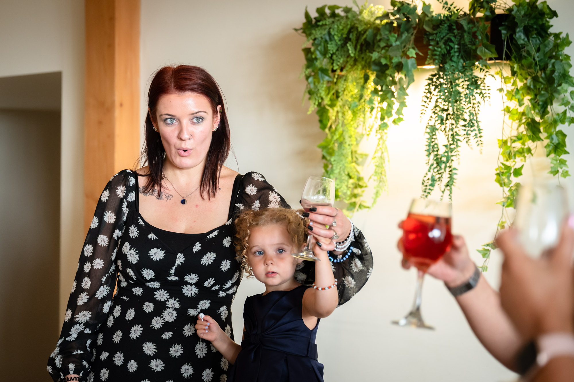 A candid group photo showing a woman and a child cheering during the final speeches at Hanbury Barns.