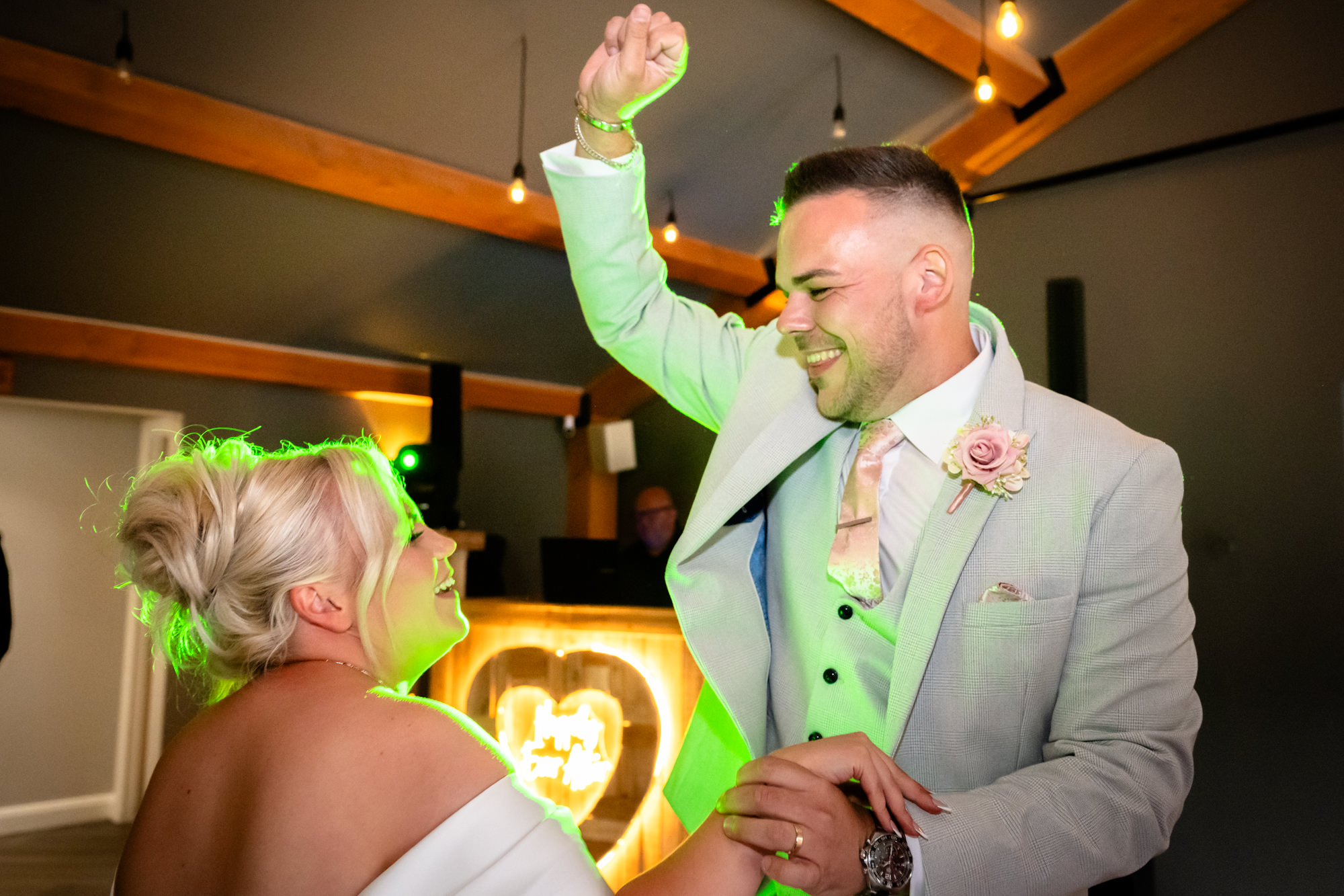Guests laughing and dancing during the vibrant evening party and wedding reception entertainment at Hanbury Barns.