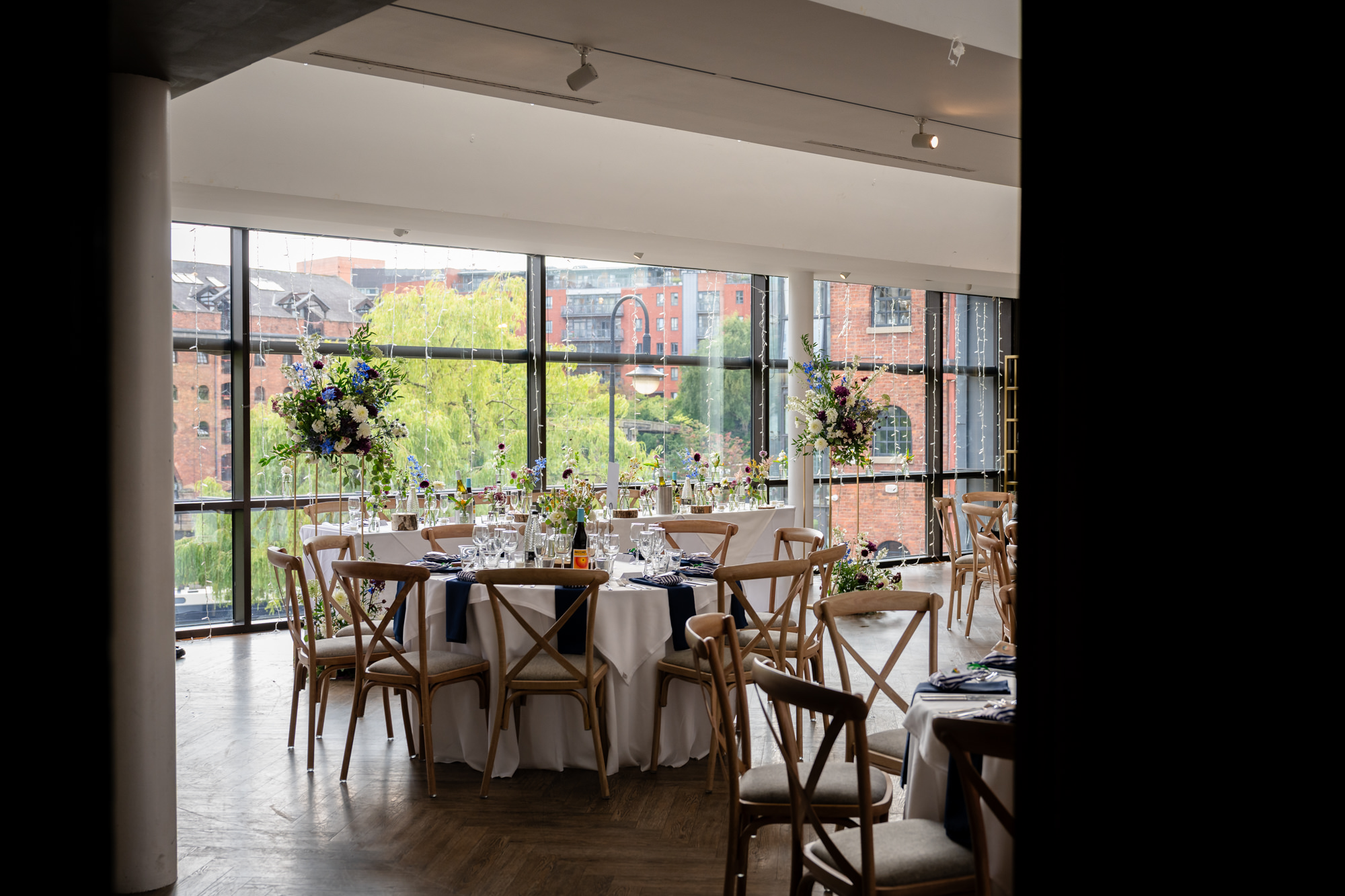A guest with her arms open, ready for a hug from the groom, at the Castlefield Rooms wedding.