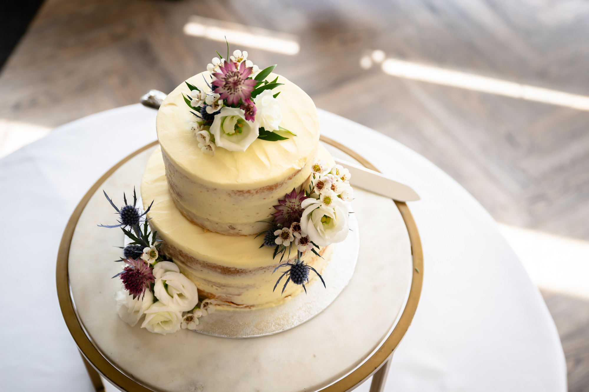 Wedding favour showing a pin badge with rainbow colours