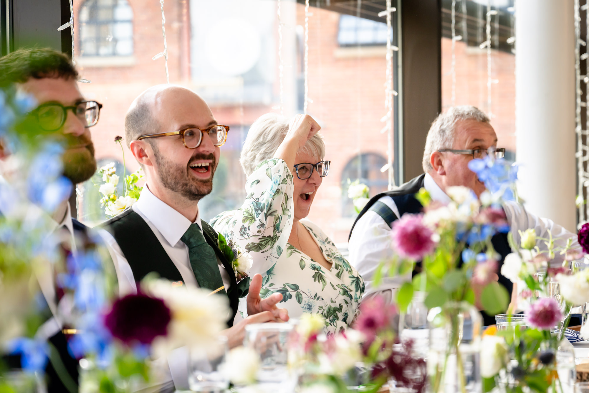 A guest listening to the speeches and smiling