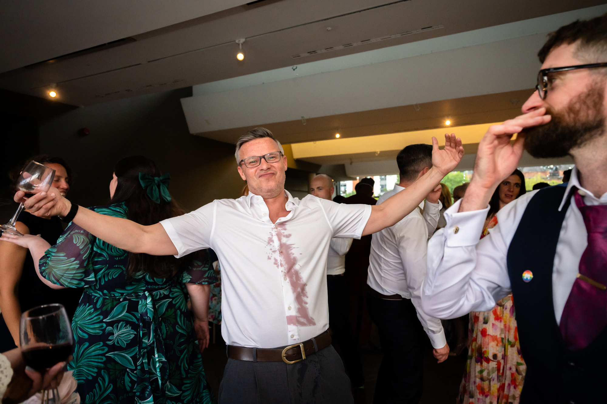 A guest passionately leads a partner during a lively, practiced dance move on the floor at the Castlefield Rooms wedding party.