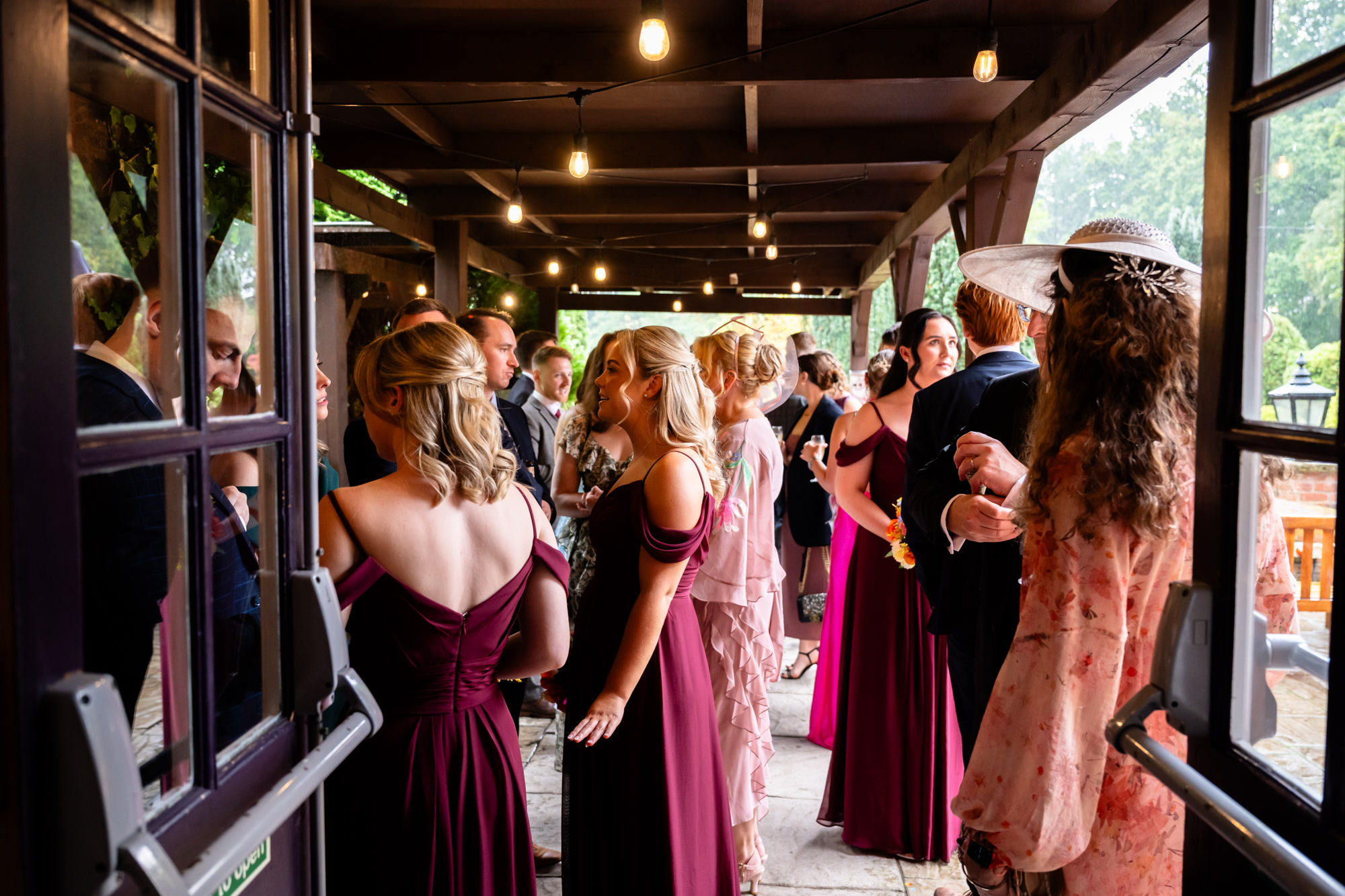 Guests mingling and chatting outside Nunsmere Hall during the drinks reception.