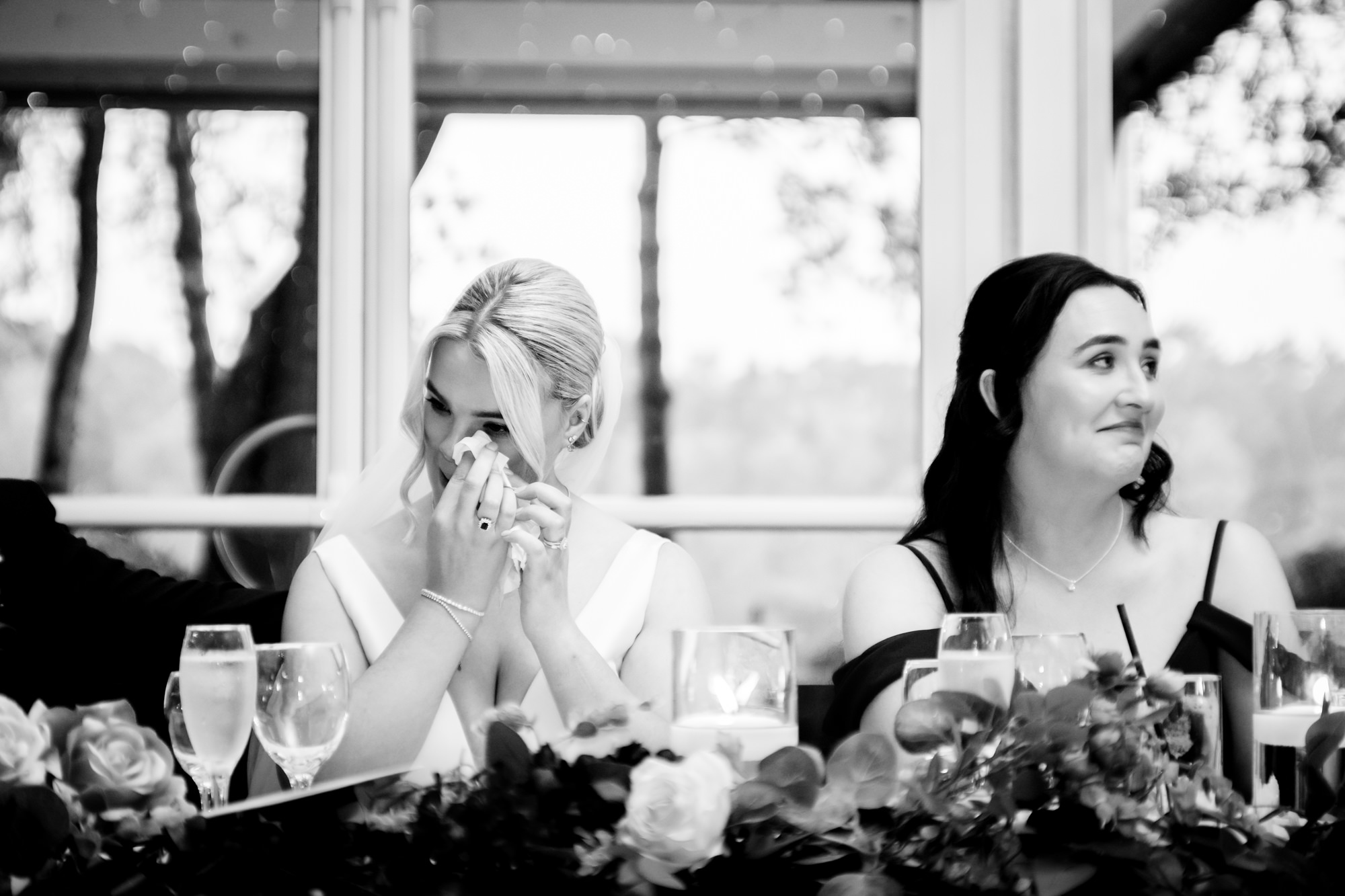A bridesmaid crying and wiping her eyes during the wedding speeches at Nunsmere Hall.