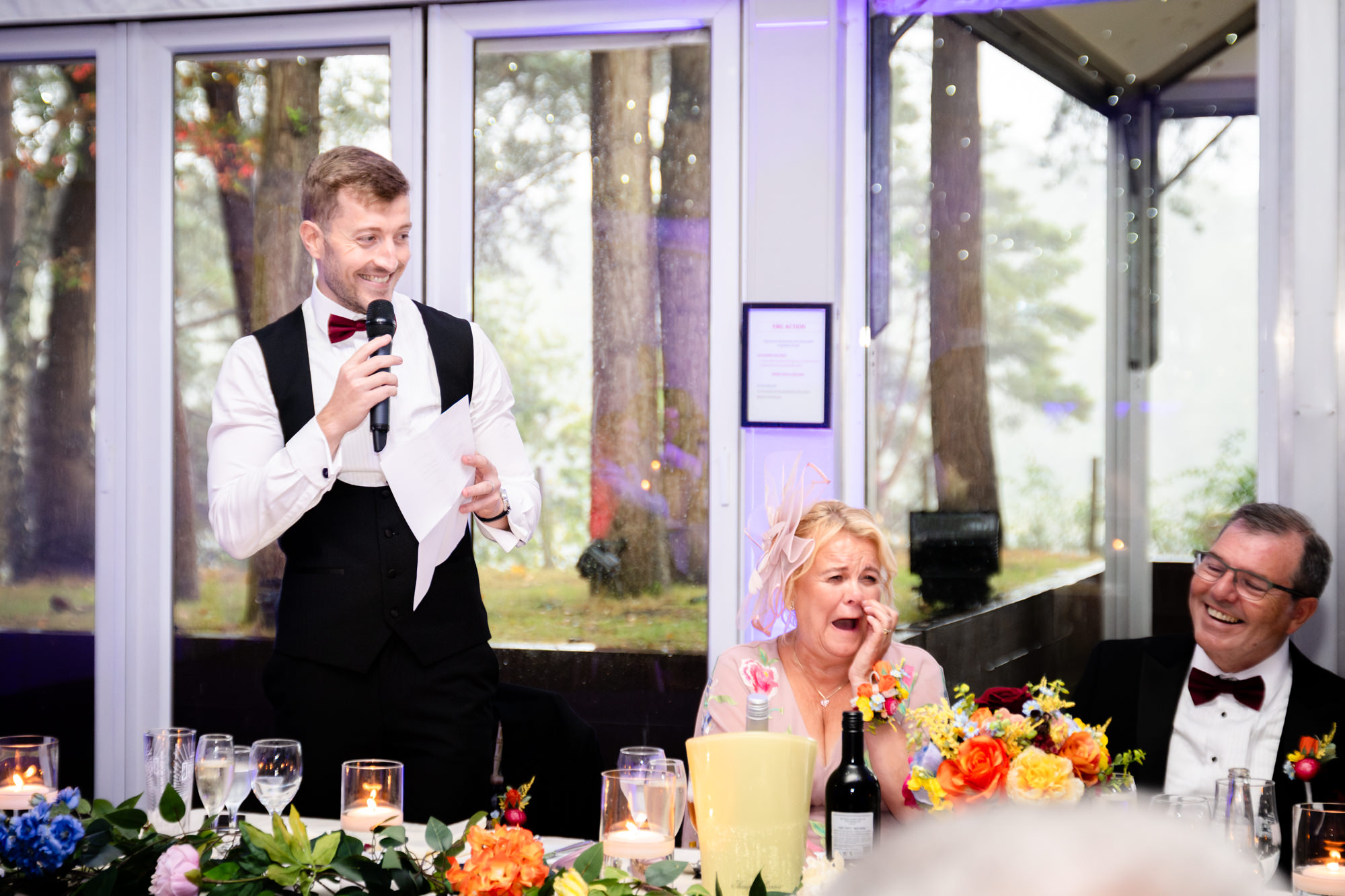 The best man standing and delivering his speech at Nunsmere Hall.