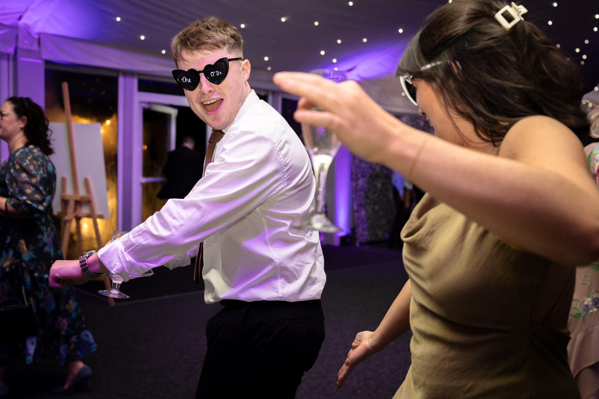 Guests dancing and having fun during the evening party of a wedding at Nunsmere Hall.