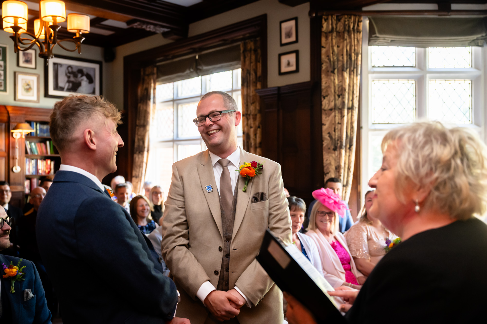 Dom smiles across at Marc during the ceremony at The Oakfield.
