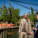 Marc and Dom walk the boardwalk past the flamingos at Chester Zoo.
