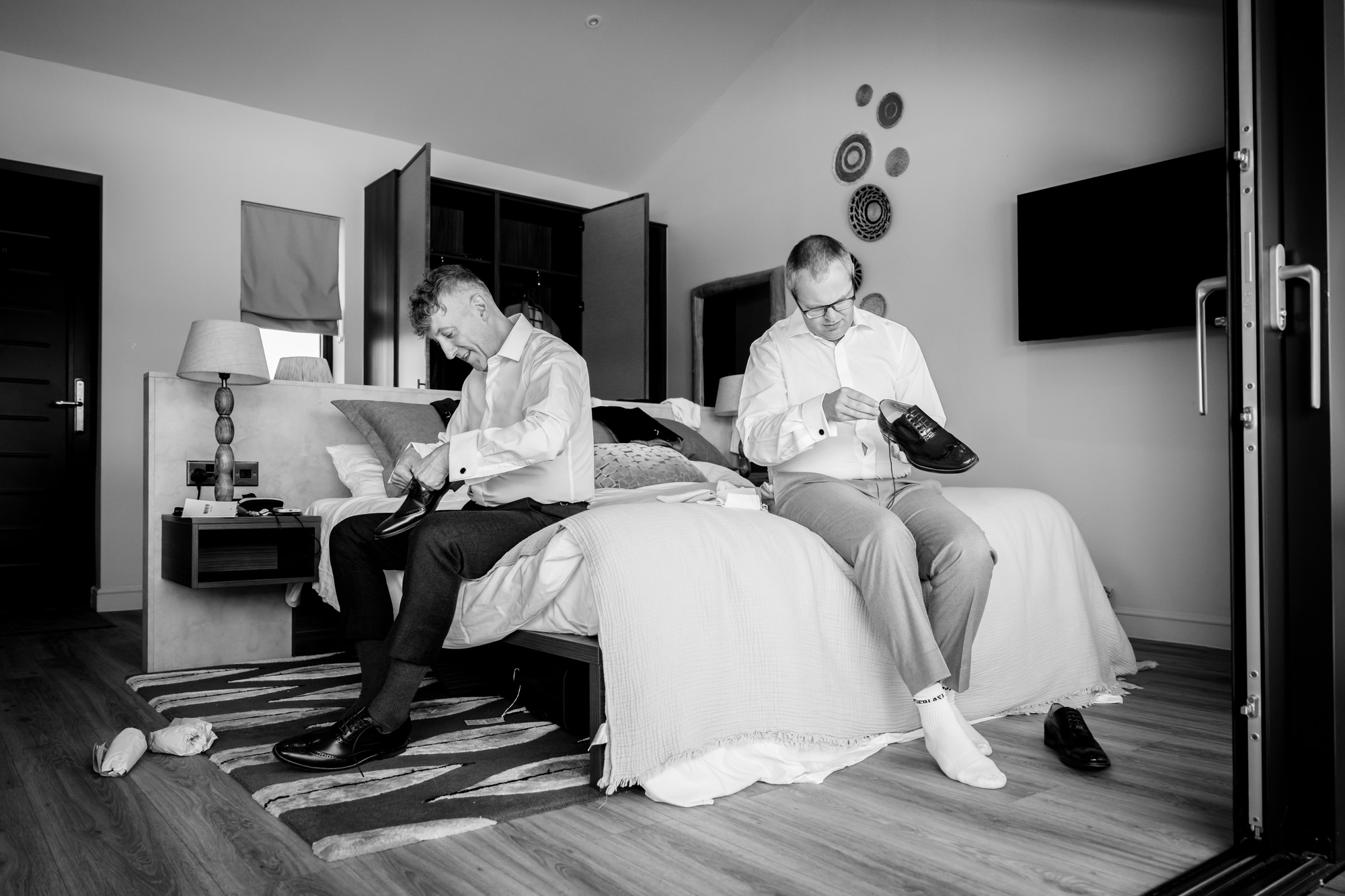 Putting on shoes before the ceremony during prep at The Reserve lodge.