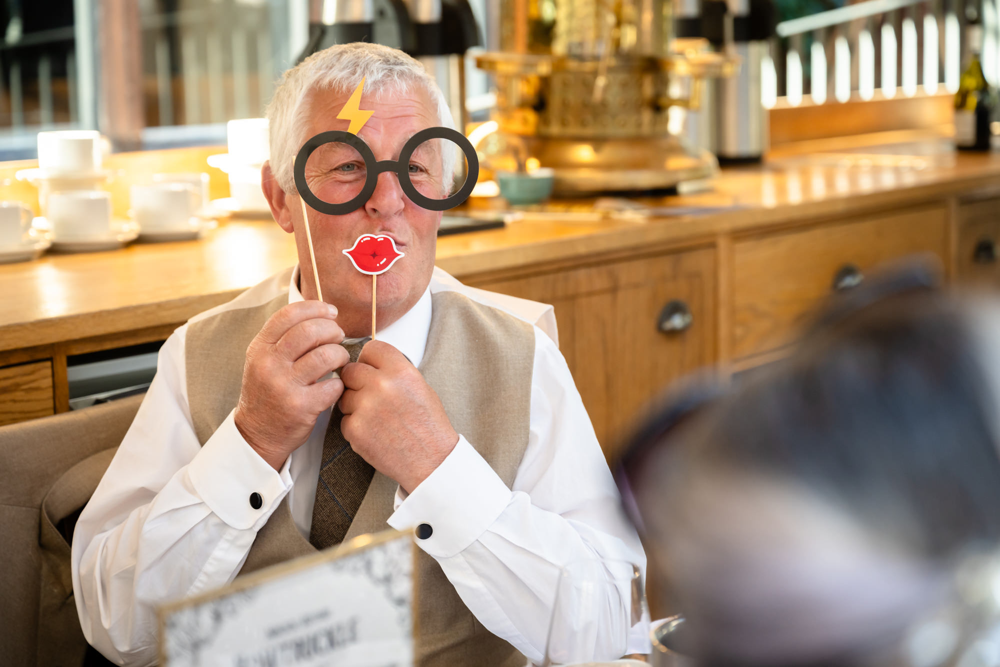 One of the grooms' fathers having fun with the Harry Potter photo booth props.