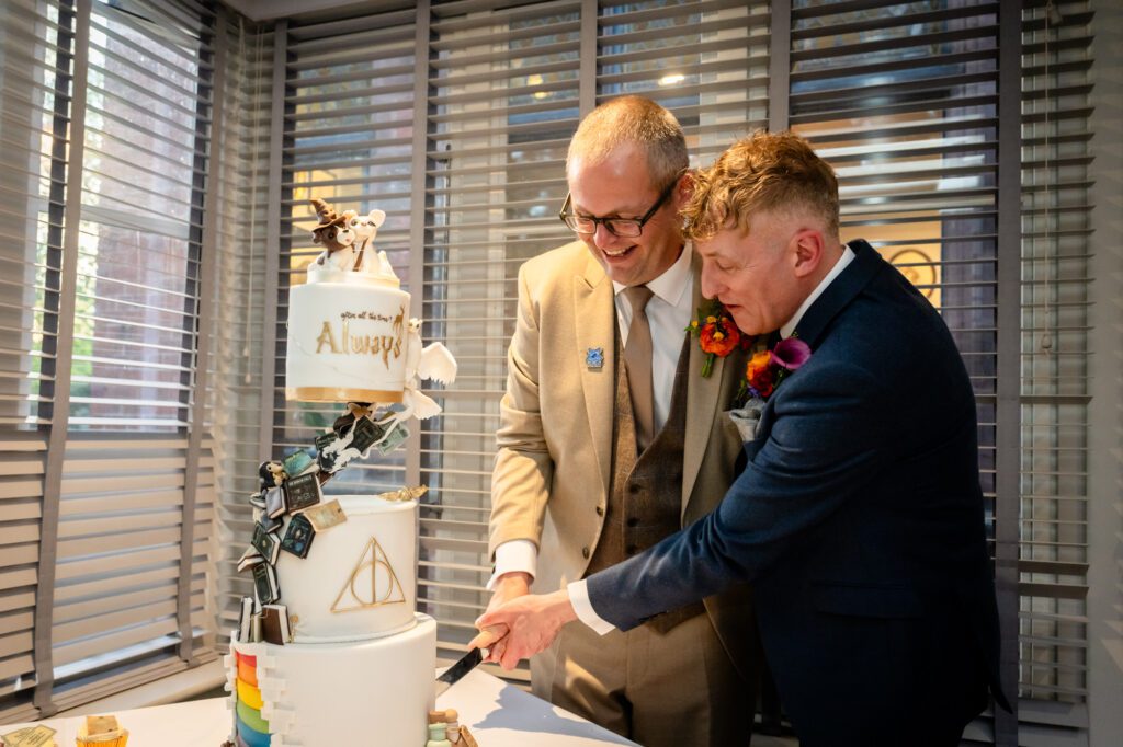 Marc and Dom cut their Harry Potter wedding cake at The Oakfield.