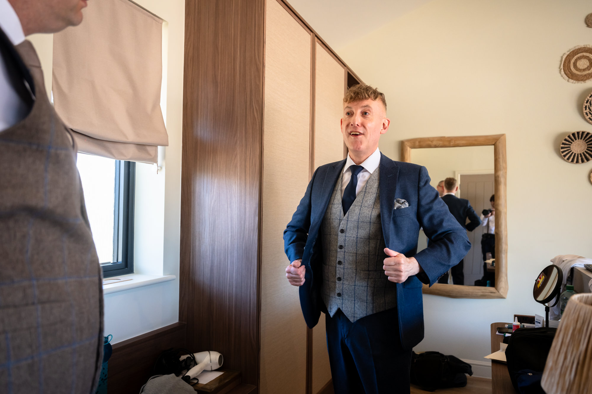 Marc adjusts his jacket in the mirror, ready for the day ahead.