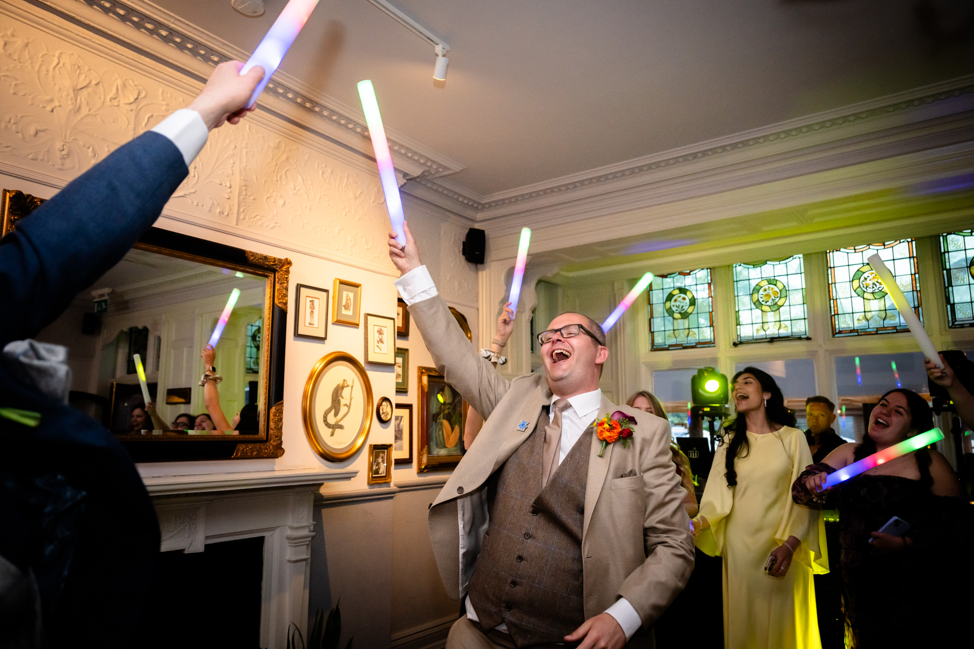 Dom celebrates with glow sticks on the dance floor.