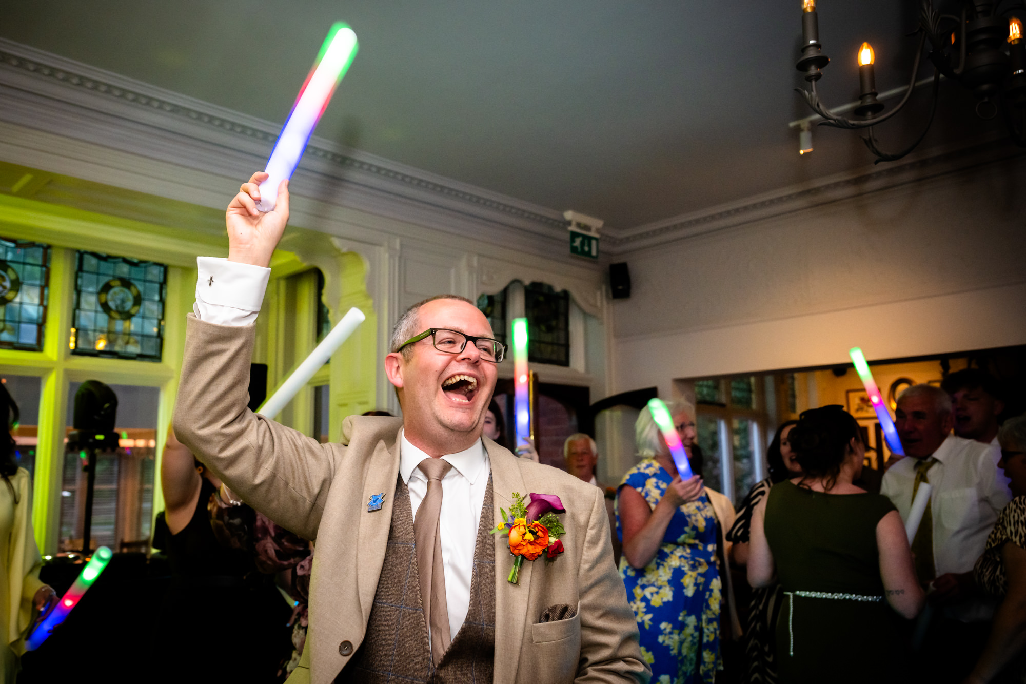 Dom cheering with a glow stick at the evening party.