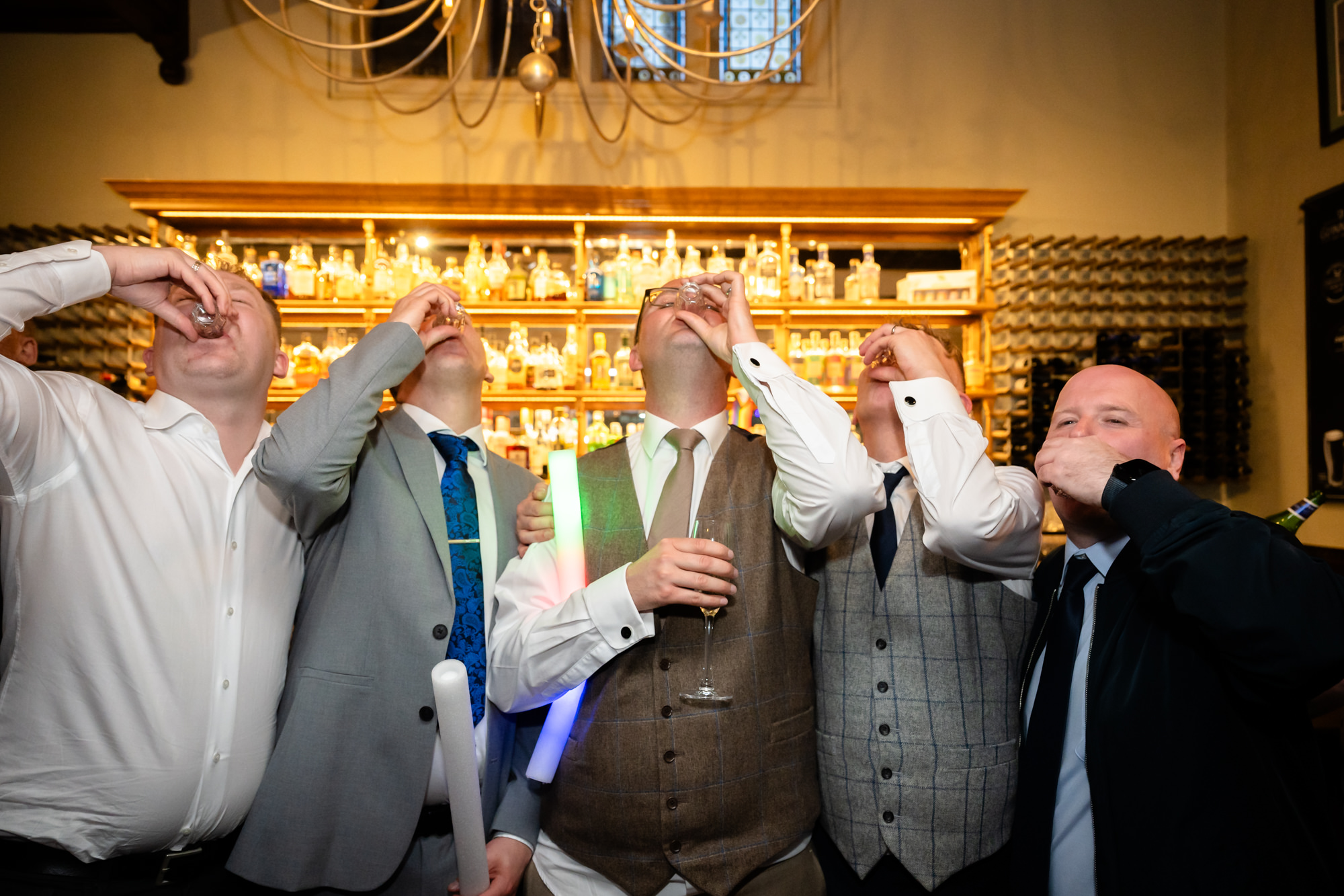 Marc, Dom and friends down a round of shots at the bar.