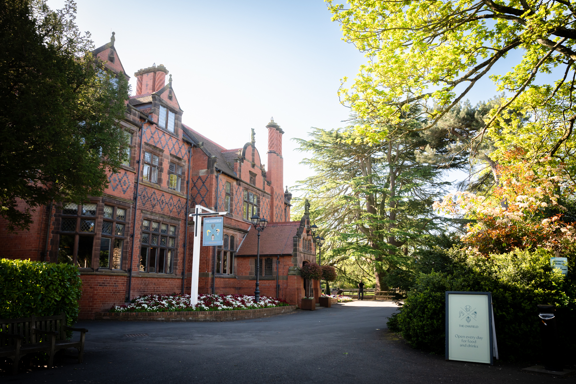 Exterior of The Oakfield at Chester Zoo, showing the Victorian red brick facade with ornate gabled roofline and decorative diamond brickwork
