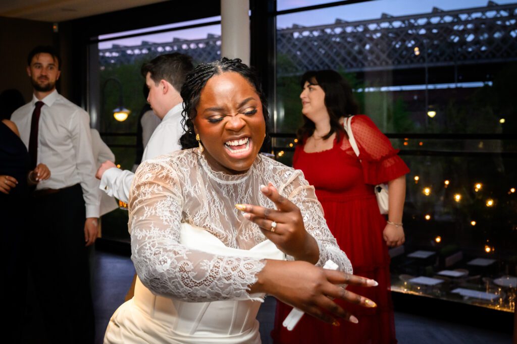 The bride dancing energetically on the dance floor during the evening reception at The Castlefield Rooms.