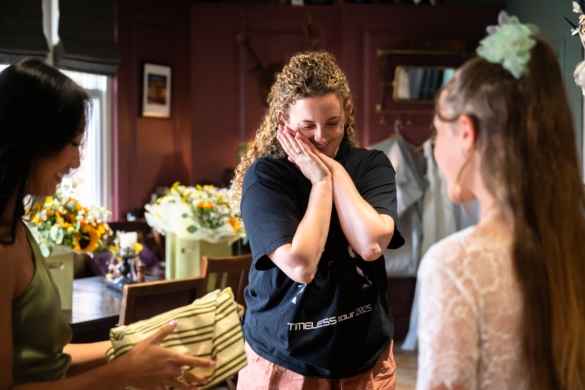 Bride wiping away tears while getting ready for the wedding