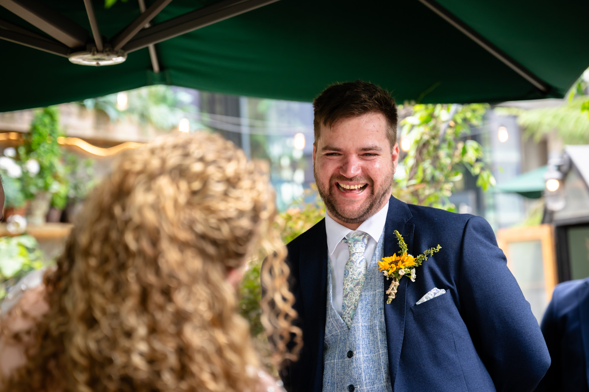 Groom laughing during the wedding ceremony
