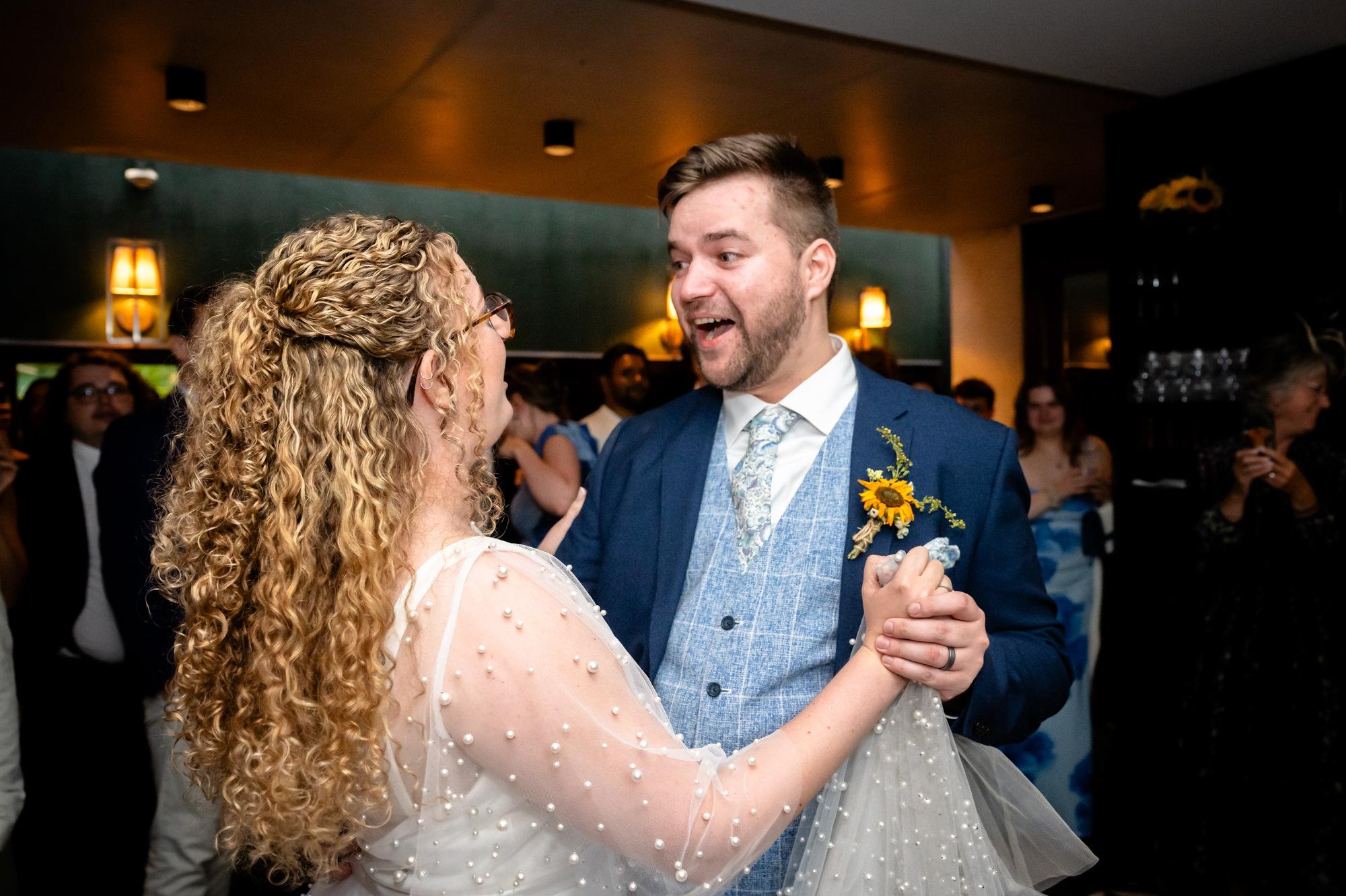 Bride and groom laughing together during their first dance