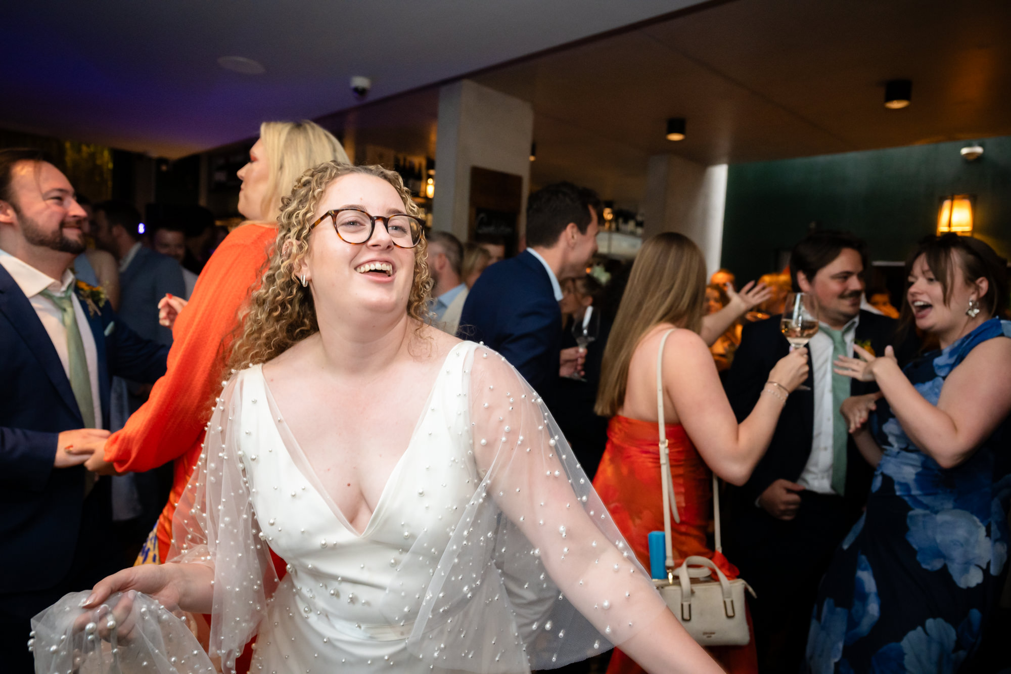 Bride dancing joyfully among the wedding guests